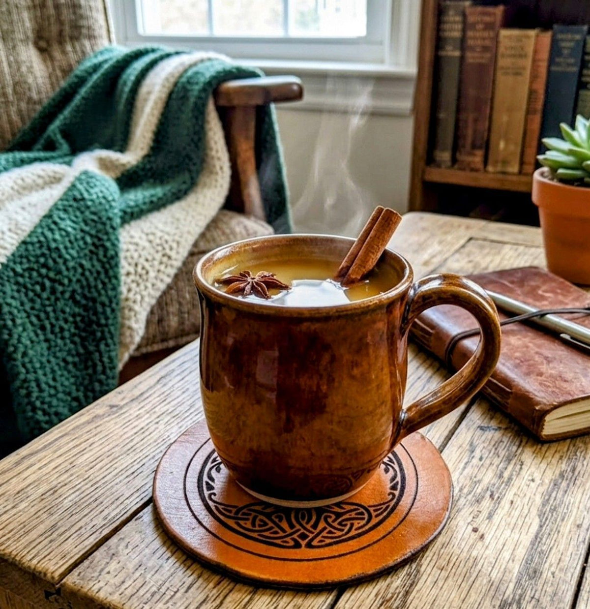 A cozy, rustic indoor scene featuring a leather journal and a steaming drink with cinnamon sticks, reflecting a warm October 