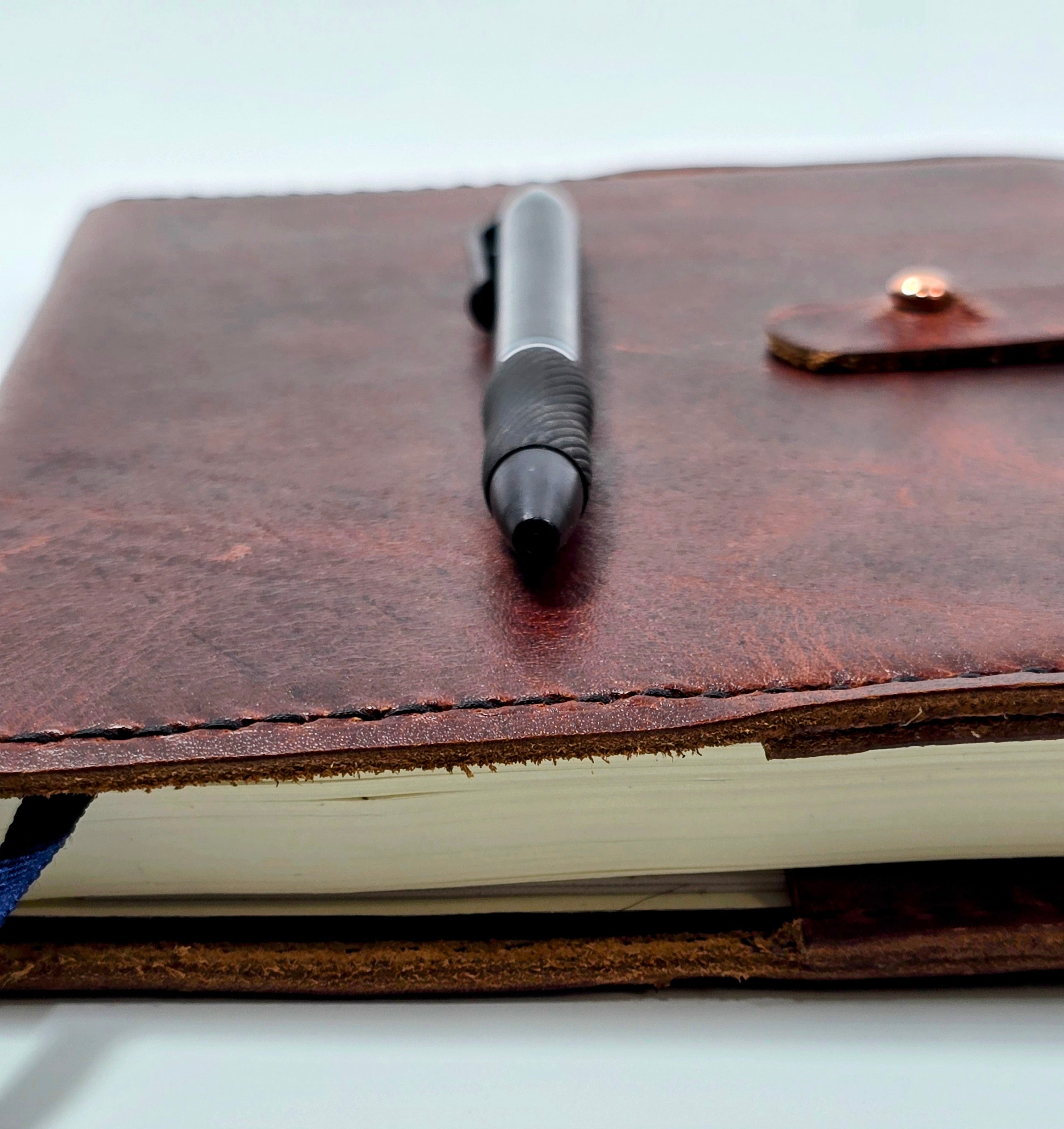 Burgundy leather journal cover -  side view of Handcrafted A5 leather notebook cover.