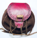 Hand-tooled bison leather belt pouch with a handmade leather closure and intricate geometric patterns.