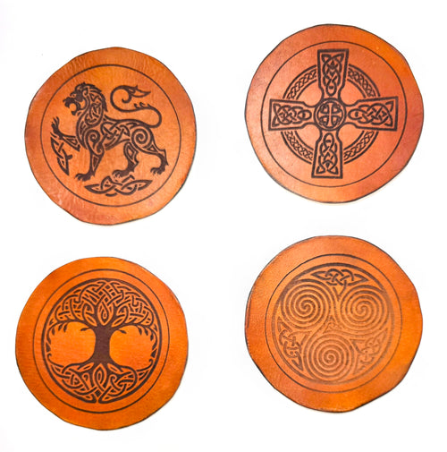 Set of 4 handmade full-grain vegetable tanned leather coasters featuring Celtic knotwork designs – Celtic lion, Celtic cross, Tree of Life, and triskelion spiral