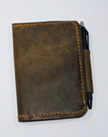 Brown leather notebook with a pen on a white background