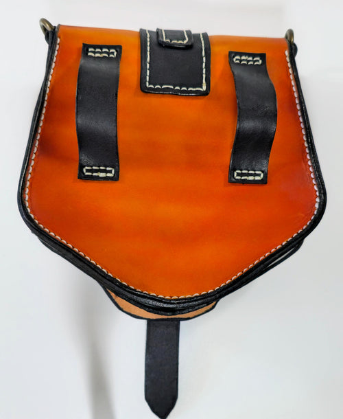 Tan and black leather pouch with black straps and stitching on a white background