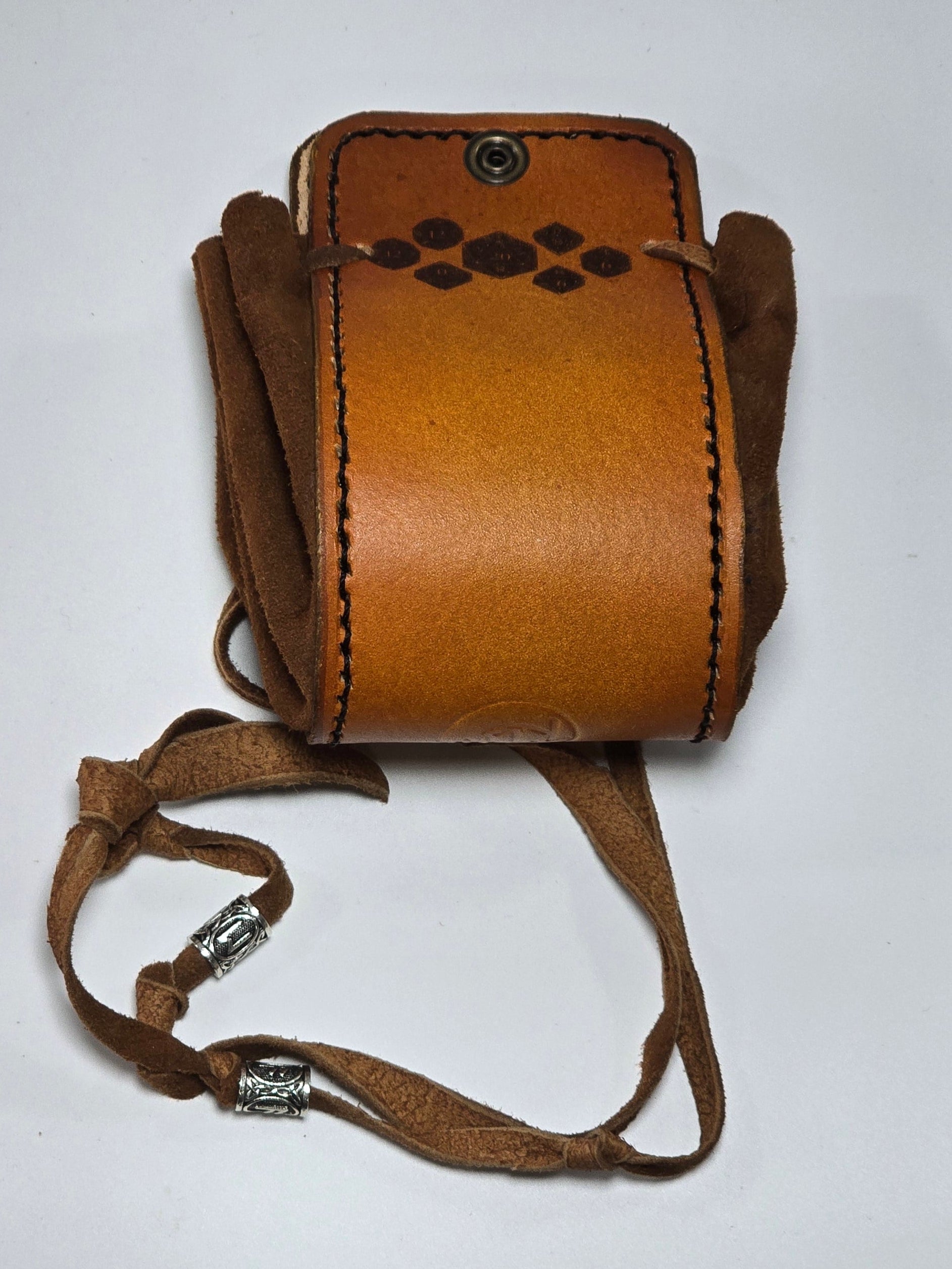 A small brown leather pouch with a matching leather strap and silver-toned metal hardware, photographed on a plain white background.