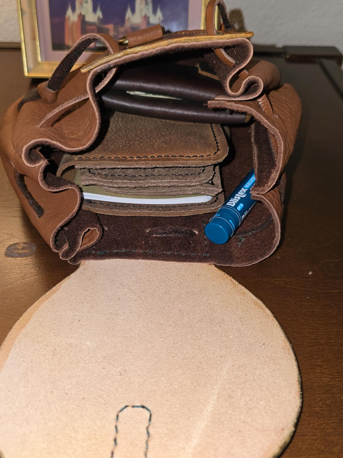 The Highland Nomad leather pouch opened to show practical everyday carry items